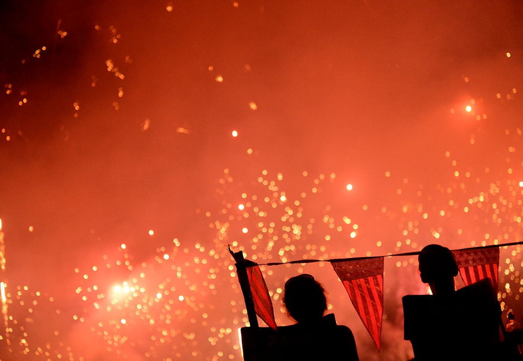 Tara Sheets and friend Racheal Hollenbeck watch the firework show with their daughters